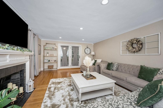 11 Florence Rd, Lowell, MA 01851 - living room featuring crown molding, french doors, recessed lighting, a fireplace with flush hearth, and wood finished floors