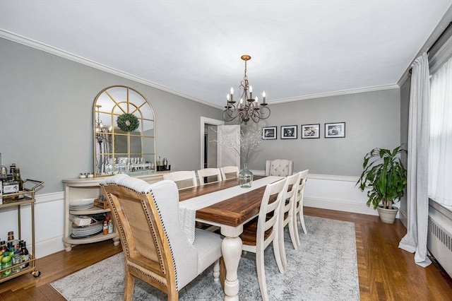 11 Florence Rd, Lowell, MA 01851 - dining space featuring a chandelier, crown molding, wood finished floors, and radiator heating unit