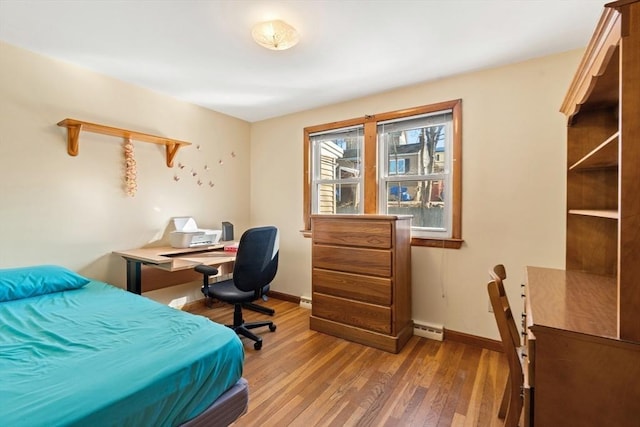 bedroom featuring wood finished floors and baseboards