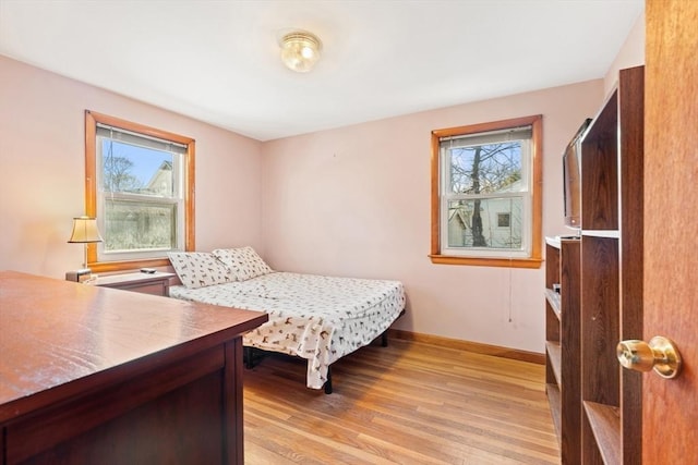 bedroom featuring light wood-type flooring and baseboards