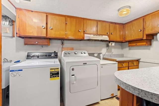 washroom with cabinet space and washing machine and clothes dryer