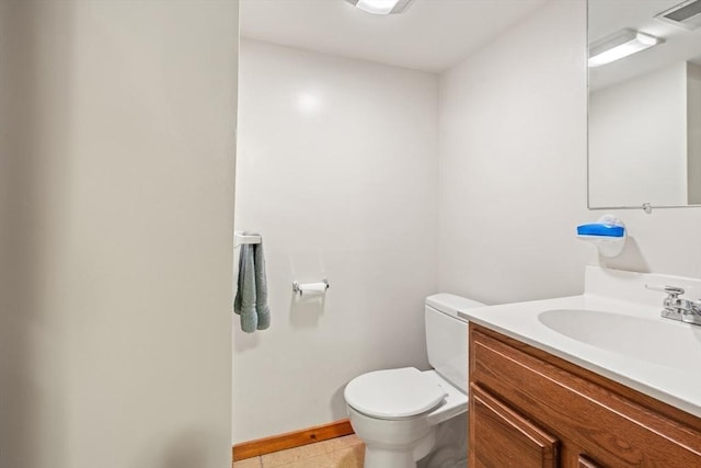 half bath featuring baseboards, visible vents, vanity, and toilet