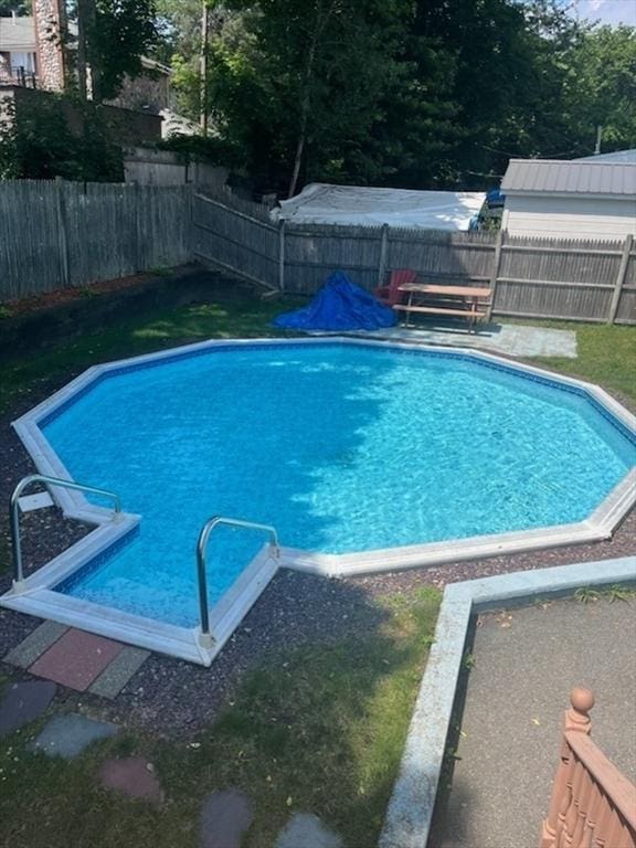 view of swimming pool featuring a fenced in pool and a fenced backyard