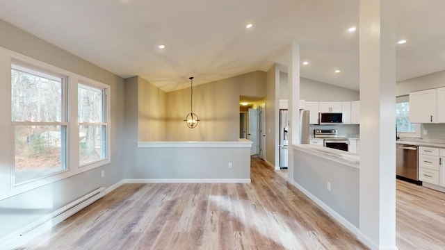 kitchen featuring white cabinetry, a baseboard heating unit, stainless steel appliances, light hardwood / wood-style floors, and decorative light fixtures