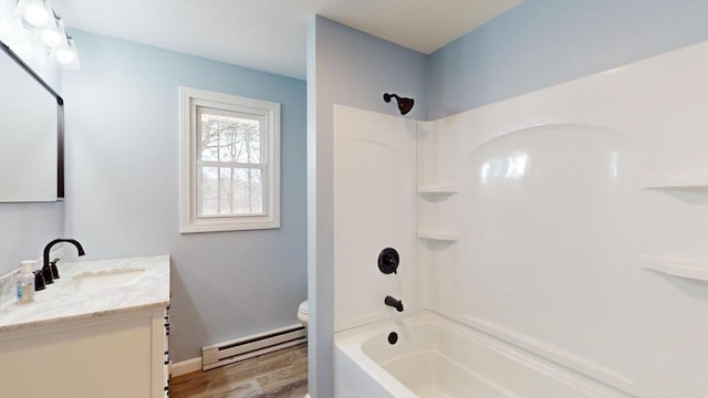 full bathroom with a baseboard heating unit, vanity, wood-type flooring, bathtub / shower combination, and toilet