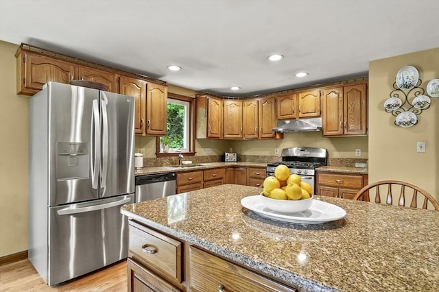 8 Messina Cir, Methuen, MA 01844 - kitchen with appliances with stainless steel finishes, under cabinet range hood, brown cabinets, light wood finished floors, and recessed lighting