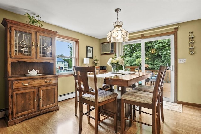 8 Messina Cir, Methuen, MA 01844 - dining room with a chandelier, light wood-type flooring, a baseboard radiator, and a wall mounted air conditioner