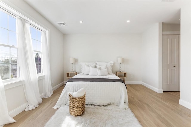 bedroom featuring a closet and light hardwood / wood-style flooring