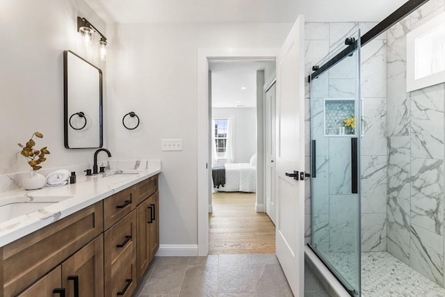 bathroom featuring a wealth of natural light, a shower with door, vanity, and wood-type flooring