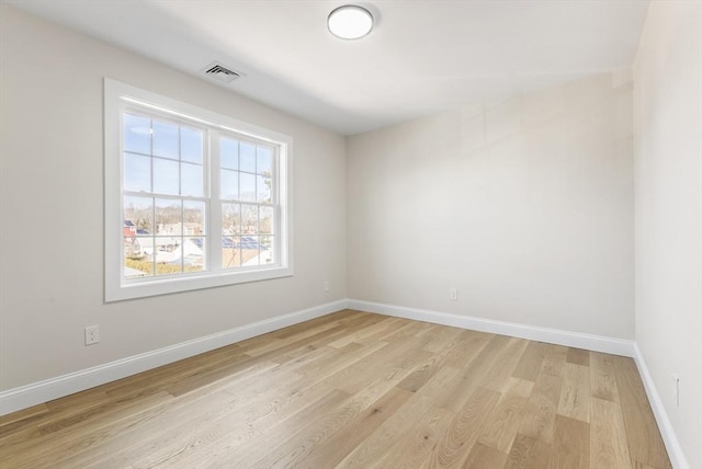 spare room featuring light hardwood / wood-style floors