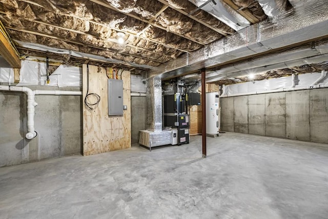 basement featuring electric panel and water heater