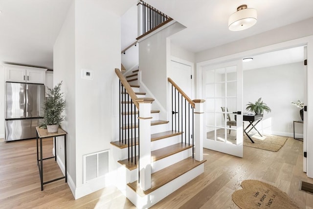 staircase with hardwood / wood-style flooring