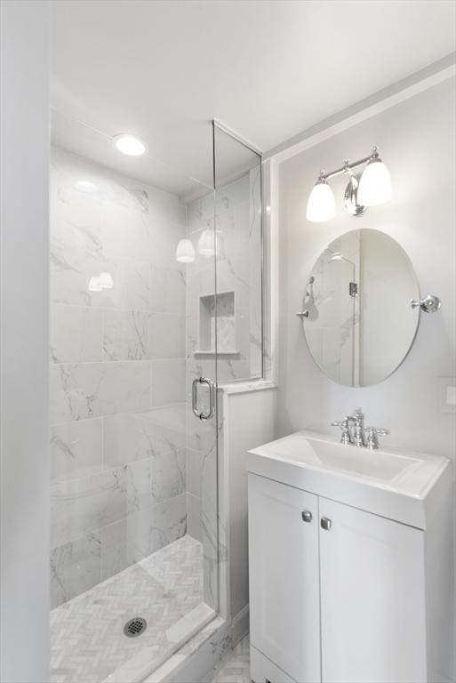 bathroom featuring vanity and an enclosed shower