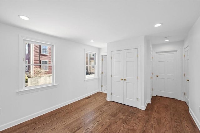 unfurnished bedroom with dark hardwood / wood-style flooring