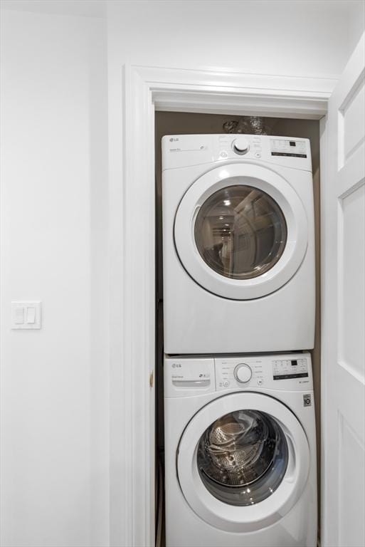 laundry area featuring stacked washing maching and dryer