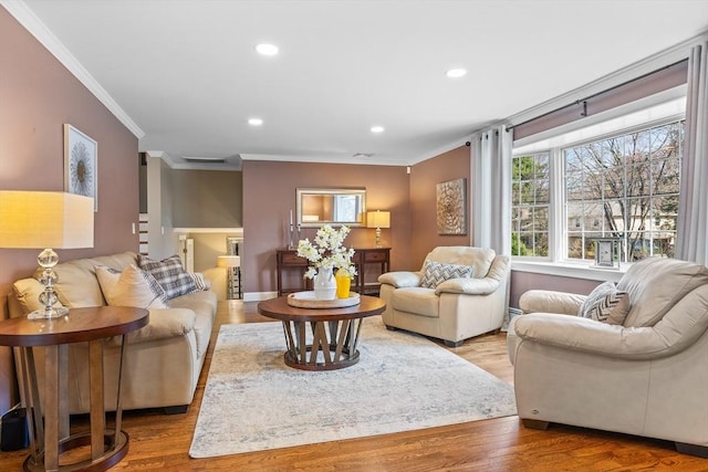 living area featuring ornamental molding, recessed lighting, and wood finished floors