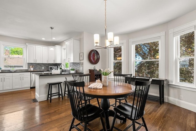 dining area featuring a chandelier, dark wood-type flooring, baseboards, and recessed lighting
