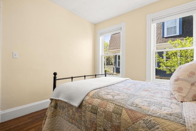bedroom with baseboards and wood finished floors