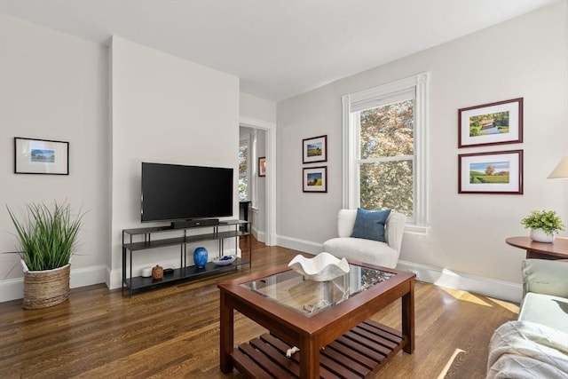 living area with wood finished floors and baseboards