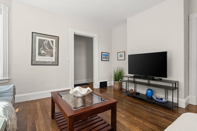 living room featuring wood finished floors and baseboards
