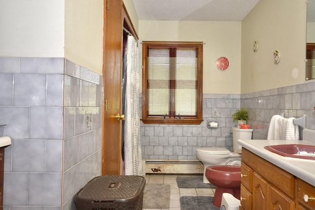 110 Lucy Little Rd, Dartmouth, MA 02747 - full bathroom featuring a bidet, vanity, tile walls, tile patterned flooring, and a baseboard heating unit