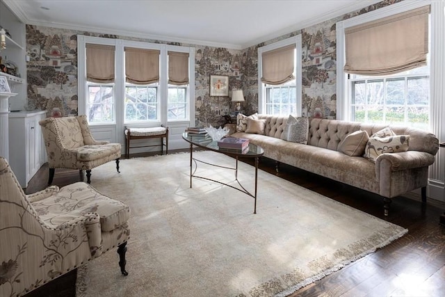 living room featuring ornamental molding, wood-type flooring, and a wealth of natural light