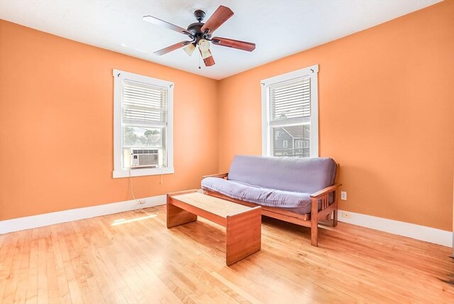 132 Myrtle St Unit 1, Waltham, MA 02453 - living area with plenty of natural light, light wood-style floors, ceiling fan, and cooling unit