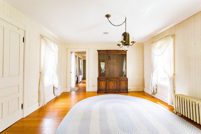 67 E Main St, West Brookfield, MA 01585 - bedroom featuring radiator, a chandelier, wallpapered walls, wood finished floors, and baseboards