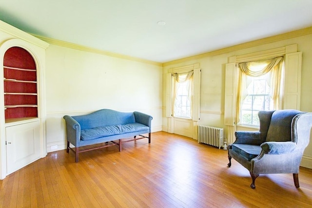 67 E Main St, West Brookfield, MA 01585 - living area with radiator heating unit, hardwood / wood-style flooring, built in shelves, and crown molding