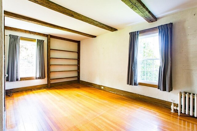 67 E Main St, West Brookfield, MA 01585 - spare room with radiator, hardwood / wood-style flooring, beamed ceiling, and baseboards