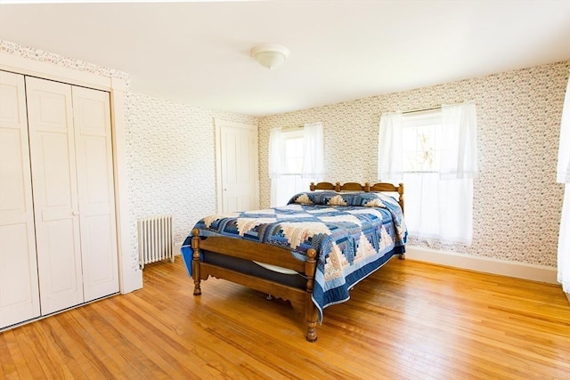 67 E Main St, West Brookfield, MA 01585 - bedroom with radiator heating unit, light wood-type flooring, wallpapered walls, and baseboards