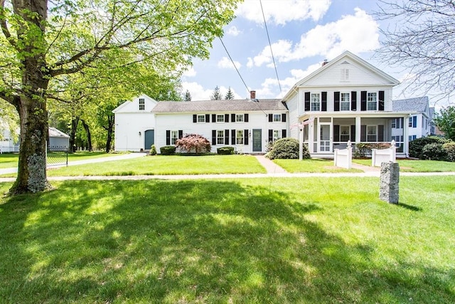 67 E Main St, West Brookfield, MA 01585 - back of property with a lawn, a chimney, and a sunroom
