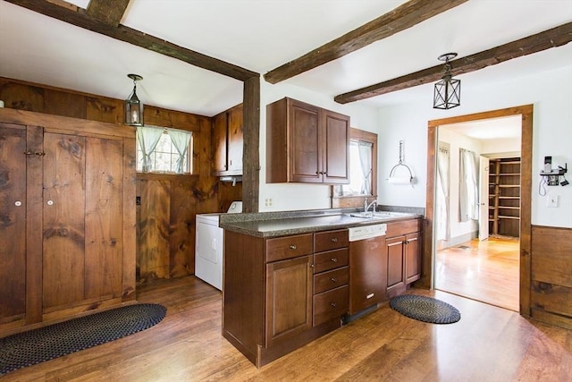 67 E Main St, West Brookfield, MA 01585 - kitchen featuring dishwashing machine, washer / dryer, wood finished floors, dark countertops, and beam ceiling