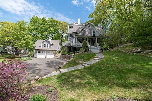 view of front facade with covered porch and a front yard