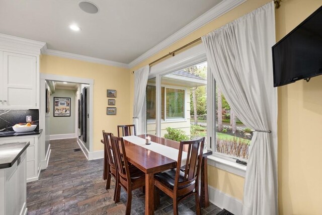 dining room with ornamental molding, baseboards, recessed lighting, and brick floors