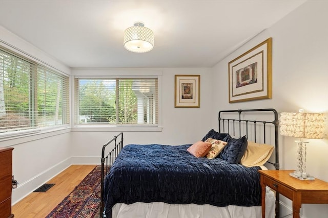 bedroom with wood finished floors and baseboards