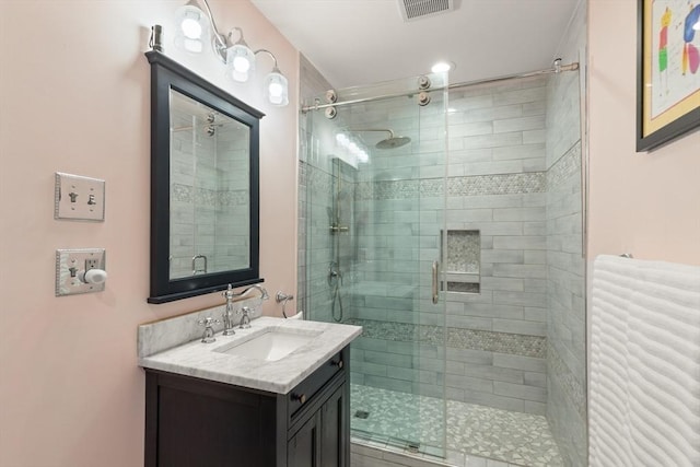 full bath featuring a stall shower and vanity