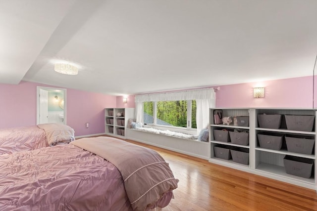 bedroom with wood finished floors and ensuite bathroom