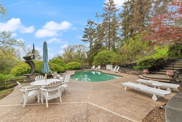 outdoor pool with a patio area