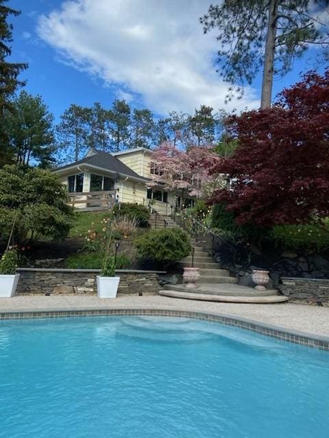 swimming pool featuring stairway