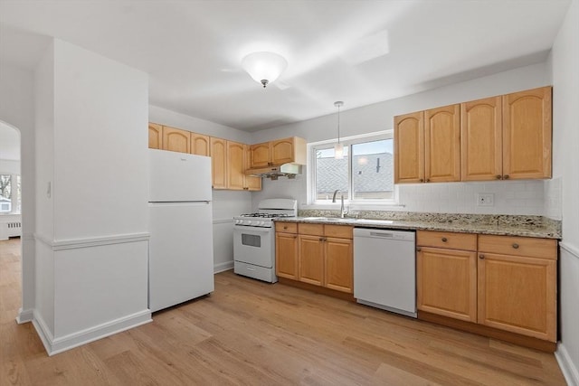 kitchen featuring white appliances, light stone countertops, radiator heating unit, and light wood-style floors