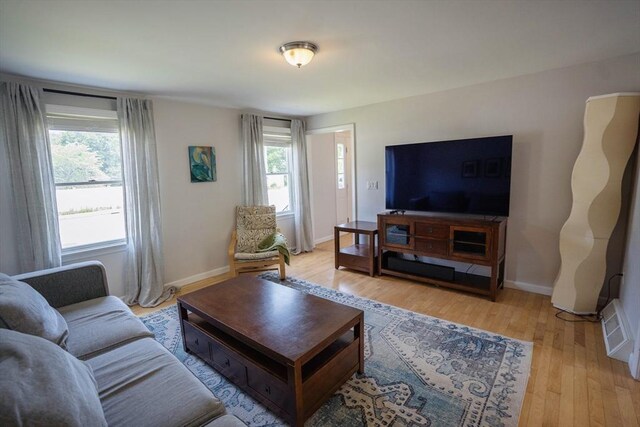 575 E St, Mansfield, MA 02048 - living room with healthy amount of natural light and light wood finished floors