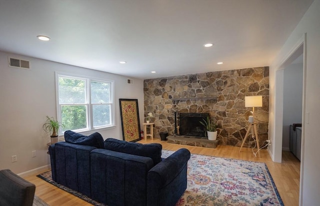 575 E St, Mansfield, MA 02048 - living room with wood finished floors, a stone fireplace, and recessed lighting