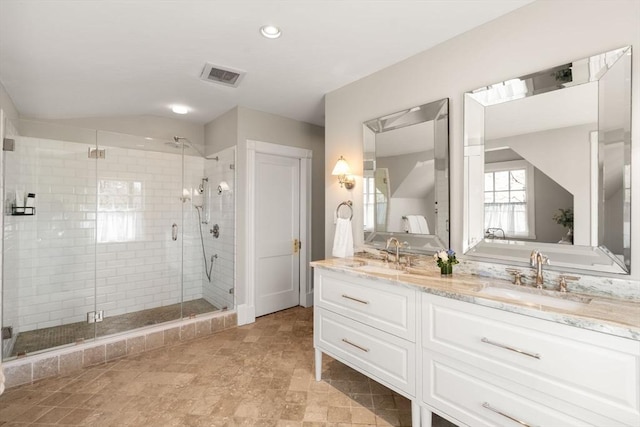 bathroom with double vanity, visible vents, a shower stall, and a sink