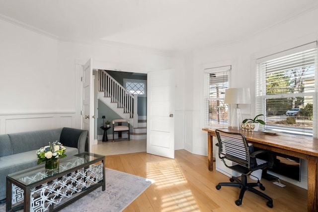 office space featuring light wood-style floors, wainscoting, and ornamental molding