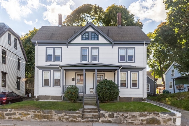 view of front of home featuring a front yard and a porch