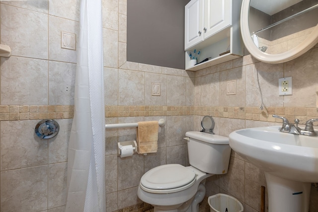 bathroom featuring tile walls, toilet, and a shower with shower curtain