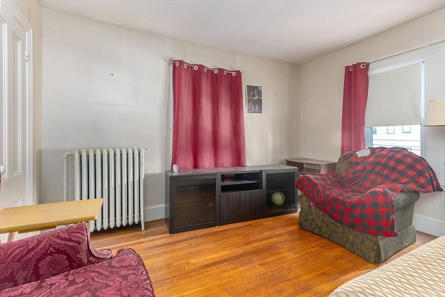 living room featuring radiator heating unit and hardwood / wood-style floors