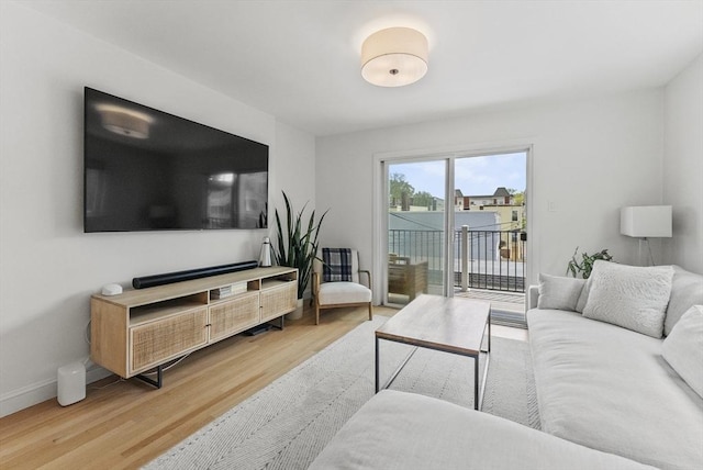 living room featuring wood finished floors and baseboards