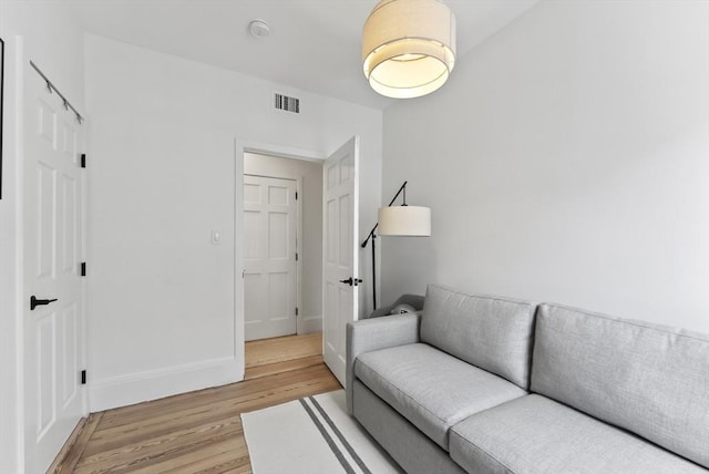living room with light wood finished floors and baseboards